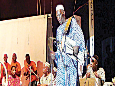 A drummer from the Agidigbo band entertaining the audience with his dexterity on the talking drum