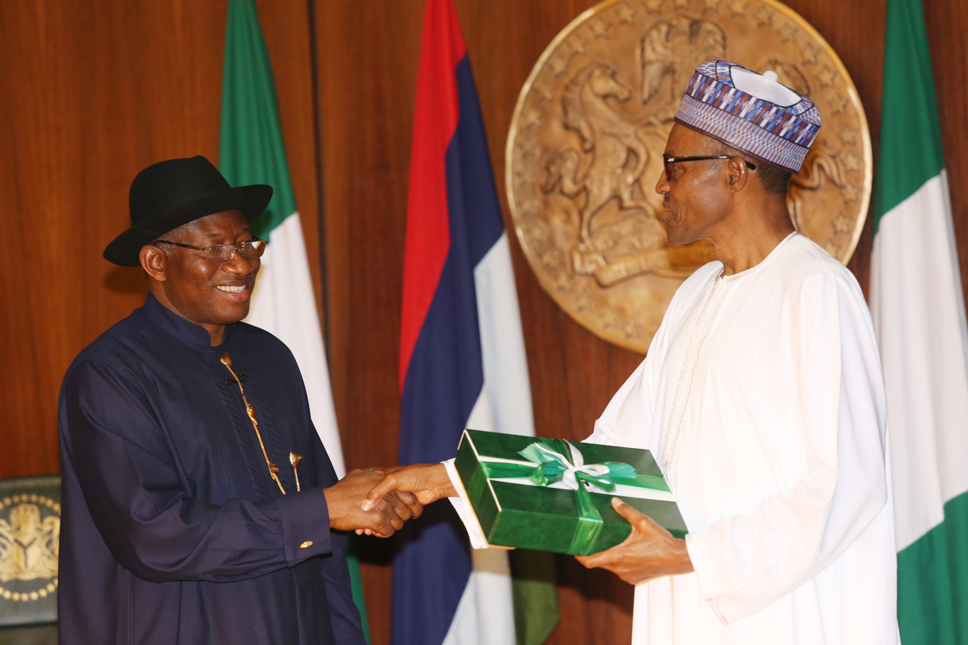 Jonathan giving the handover notes to Buhari