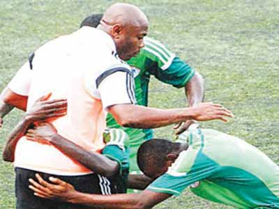 The players celebrate with Coach Emmanuel Amuneke