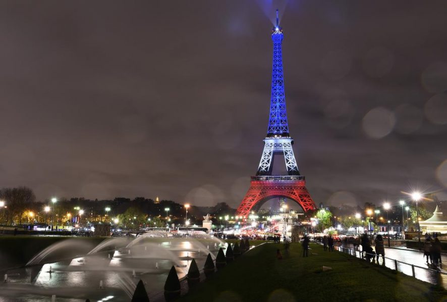A photo taken on November 17, 2015 in Paris shows the Eiffel Tower illuminated with the French national colors in tribute to the victims of the November 13, 2015 Paris terror attacks. AFP PHOTO / BERTRAND GUAY (Photo credit should read BERTRAND GUAY/AFP/Getty Images)