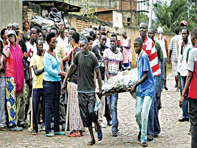 Burundi photo caption: Men carry away a body in the Nyakabiga neighbourhood of Bujumbura, Burundi on Saturday [AP Photo]