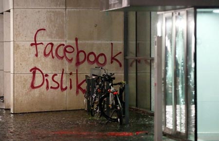 The message "facebook Dislike" is written on the wall of a building where US social media giant Facebook has its German headquarters in Hamburg, northern Germany, on December 13, 2015. AFP PHOTO / DPA / BODO MARKS
