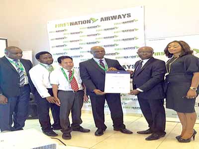 Area Manager, South West Africa, (IATA), Mr. Samson Fatokun (2nd right) representing IOSA certificate to First Nation Airline led by the Director, Flight Operations of the airline, Captain Chimara Imediegwu (3rd right) and other officials of the airline in Lagos.