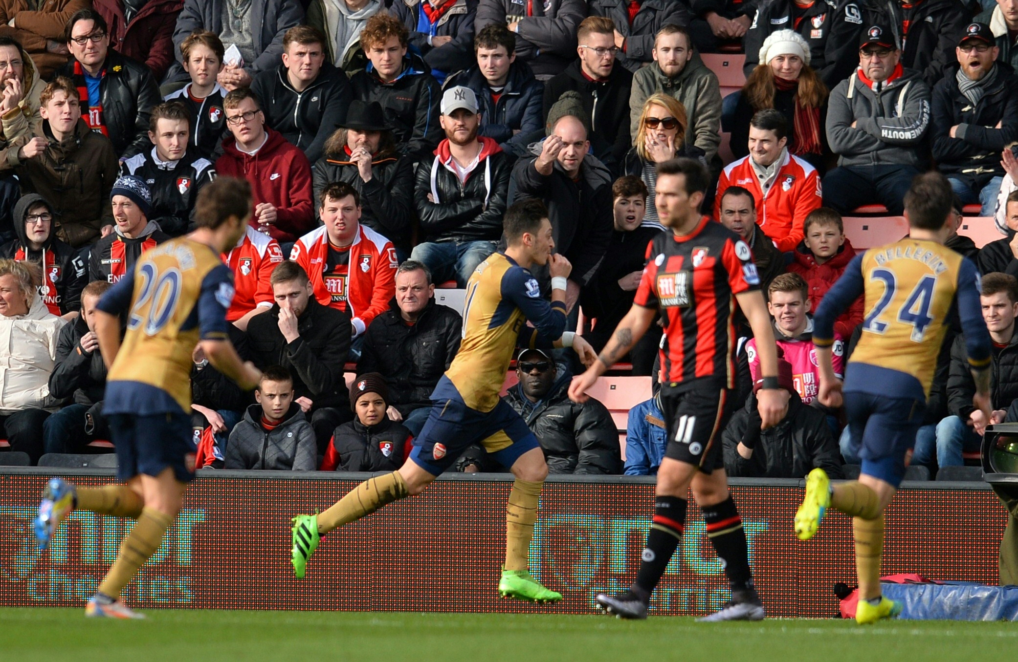 Arsenal's German midfielder Mesut Ozil (C) celebrates scoring his team's first goal during the English Premier League football match between Bournemouth and Arsenal at the Vitality Stadium in Bournemouth, southern England on February 7, 2016. / AFP / GLYN KIRK / RESTRICTED TO EDITORIAL USE. No use with unauthorized audio, video, data, fixture lists, club/league logos or 'live' services. Online in-match use limited to 75 images, no video emulation. No use in betting, games or single club/league/player publications. /
