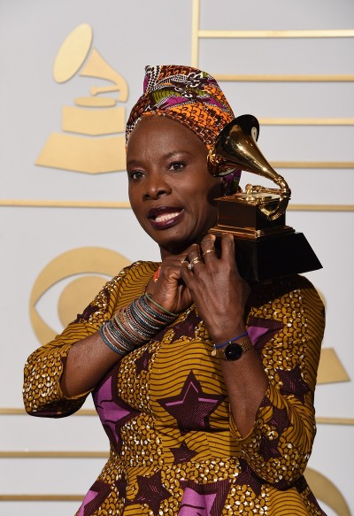Angelique Kidjo poses with her Best World Music Album trophy for "Sings" in the press room during the 58th Annual Grammy Music Awards in Los Angeles on February 15, 2016. AFP PHOTO / MARK RALSTON / AFP / MARK RALSTON
