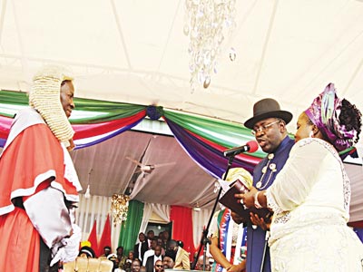 Chief Judge of Bayelsa State, Justice Kate Abiri (left) administering the oath of office to Seriake Dickson, (2nd right), supported by his wife, Rachael (right) during his swearing-in for a secod term as governor of Bayelsa State at the Samson Siasia Sports Complex in Yenagoa. 