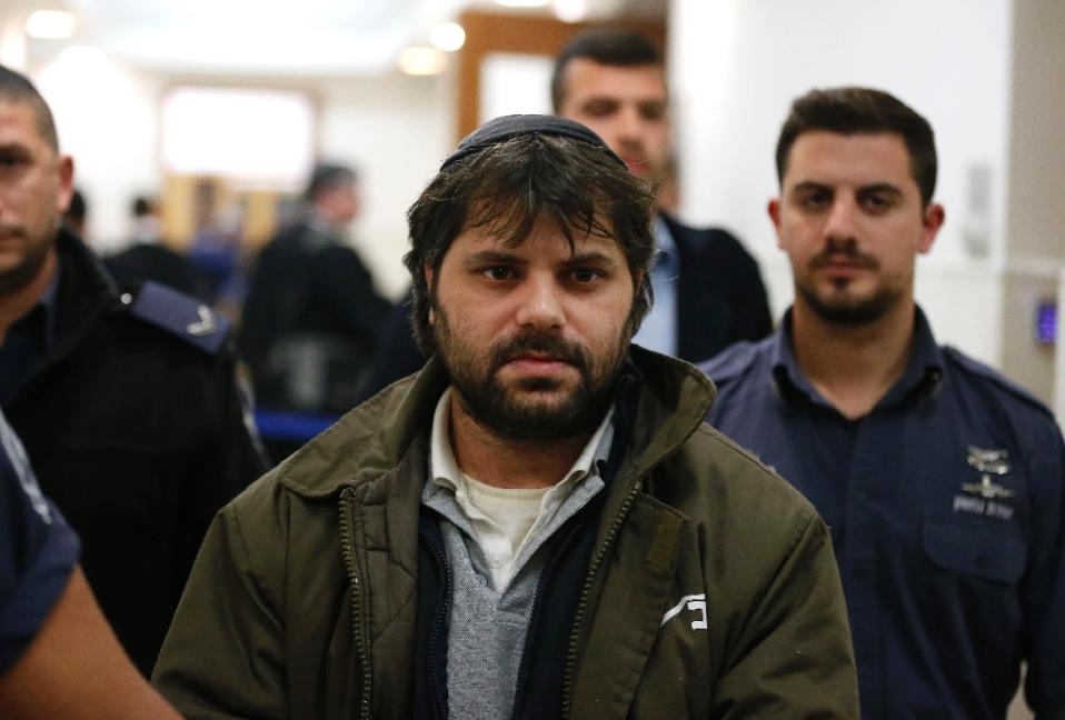 Israeli Yosef Haim Ben-David (C) the prime suspect, who was charged along with two minors for the abduction and murder of the Palestinian teenager Mohammed Abu Khdeir, is escorted by Israeli policemen at the district court in Jerusalem on December 20 (AFP Photo/Ahmad Gharabli)