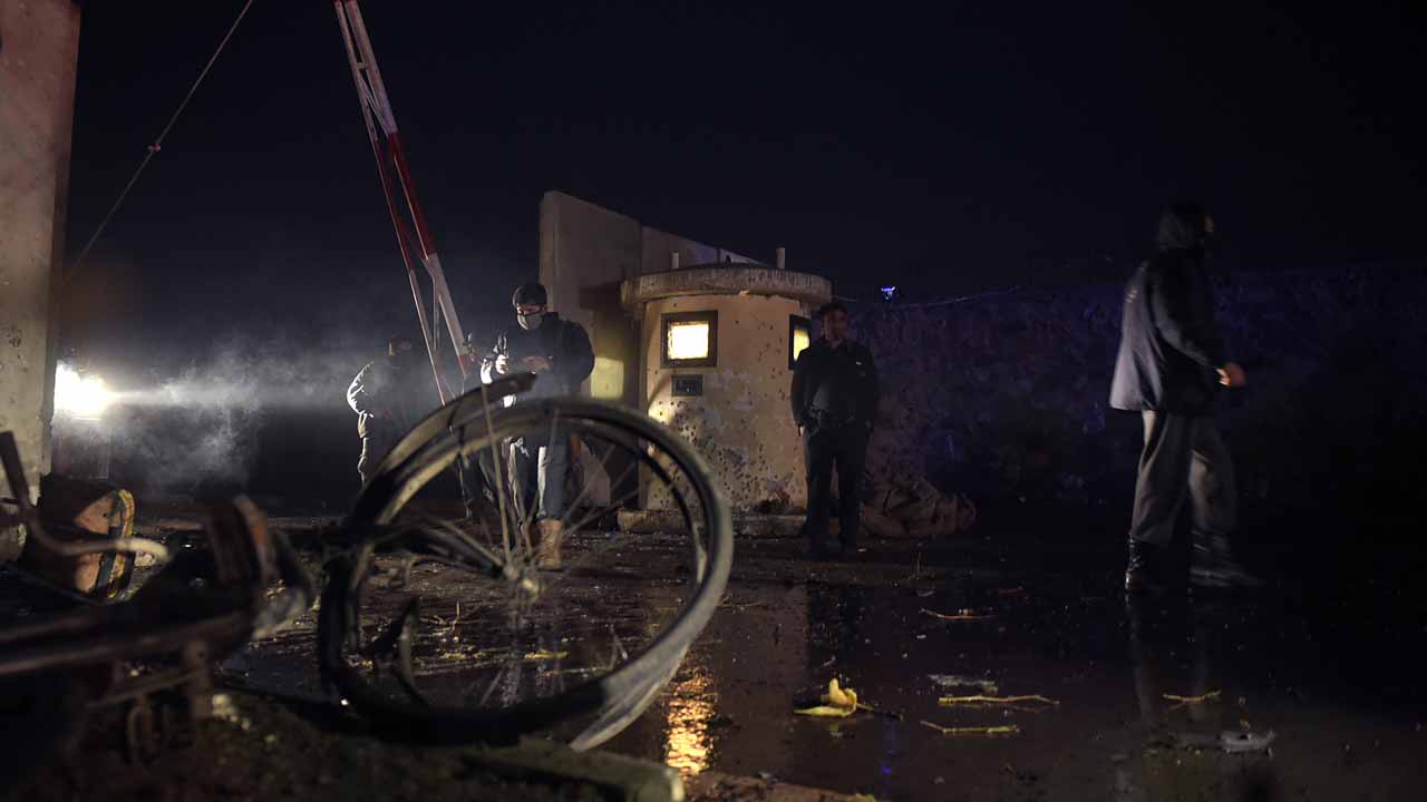 Afghan security personnel stand in front of damaged gate after twin blasts struck near the Afghan parliament in Kabul on January 10, 2017. Twin Taliban blasts struck near the Afghan parliament in Kabul January 10, killing at least 30 people and wounding 80 in a rush-hour attack that shattered a relative lull in violence in the capital. The bombings came just hours after a Taliban suicide bomber killed seven people in Lashkar Gah, the capital of the volatile southern province of Helmand, as the militants ramp up attacks. WAKIL KOHSAR / AFP