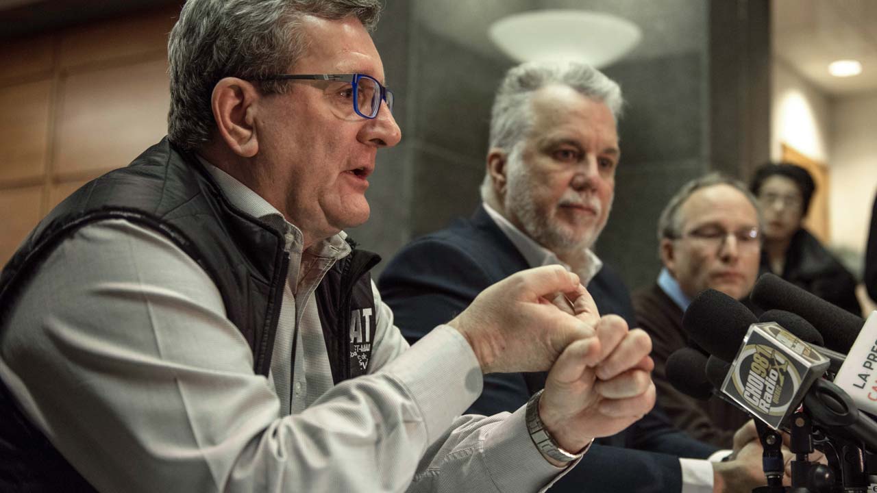 L-R: Régis Labeaume Quebec city mayor, Philippe Couillard Quebec prime minister and Martin Coiteux minister of Public Security, hold a press conference following a shooting in a mosque at the Québec City Islamic cultural center in Quebec city on January 30, 2017 Two arrests have been made after five people were reportedly shot dead in an attack on a mosque in Québec City, Canada. PHOTO: Alice Chiche / AFP