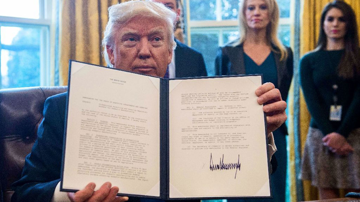 US President Donald Trump shows one of the executive orders he signed in the Oval Office at the White House on January 24, 2017 US President Donald Trump shows one of the executive orders he signed in the Oval Office at the White House on January 24, 2017 (AFP Photo/NICHOLAS KAMM)