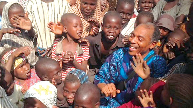  Femi Kuti in the midst of the kids during the visit