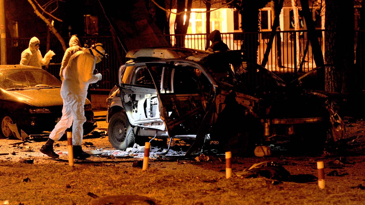 Montenegran police officers investigate a crime scene in the capital Podgorica on January 19, 2017. Heavily-armed police are guarding the streets of Montenegro's capital after a spike in gangland violence rattled the Balkan country, which is on the brink of joining NATO. Drug mafia feuds began in the coastal towns of Bar and Kotor, hotbeds of organised crime, where anti-terrorist police swooped in to tackle the deadly rivalries last summer as tourists came and went on cruise ships. But the troubles have come to the streets of the capital Podgorica in the past few weeks, with two people killed and two others seriously injured in three explosives. SAVO PRELEVIC / AFP