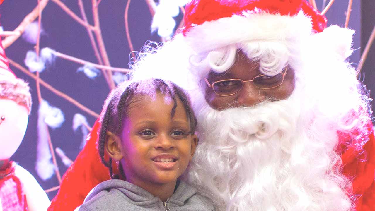 Santa with a child at the launch.
