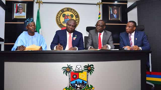 Lagos State Governor Akinwunmi Ambode (second left), Chairman, House Committee on Appropriation, Rotimi Olowo (left), Commissioner for Finance, Economic Planning & Budget, Mr. Akinyemi Ashade (second right) and Secretary to the State Government, Mr. Tunji Bello (right) at the signing into law of the 2017 Appropriation Bill at the Lagos House, Ikeja…yesterday