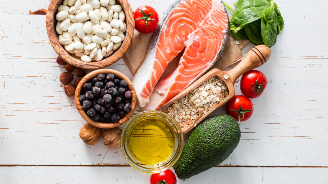 Selection of food that is good for the heart, white wood background