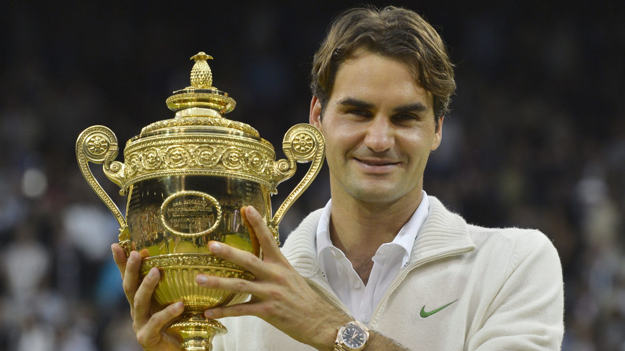 Roger Federer of Switzerland holds the winners trophy after defeating Andy Murray of Britain in their men’s final tennis match at the Wimbledon Tennis Championships in London