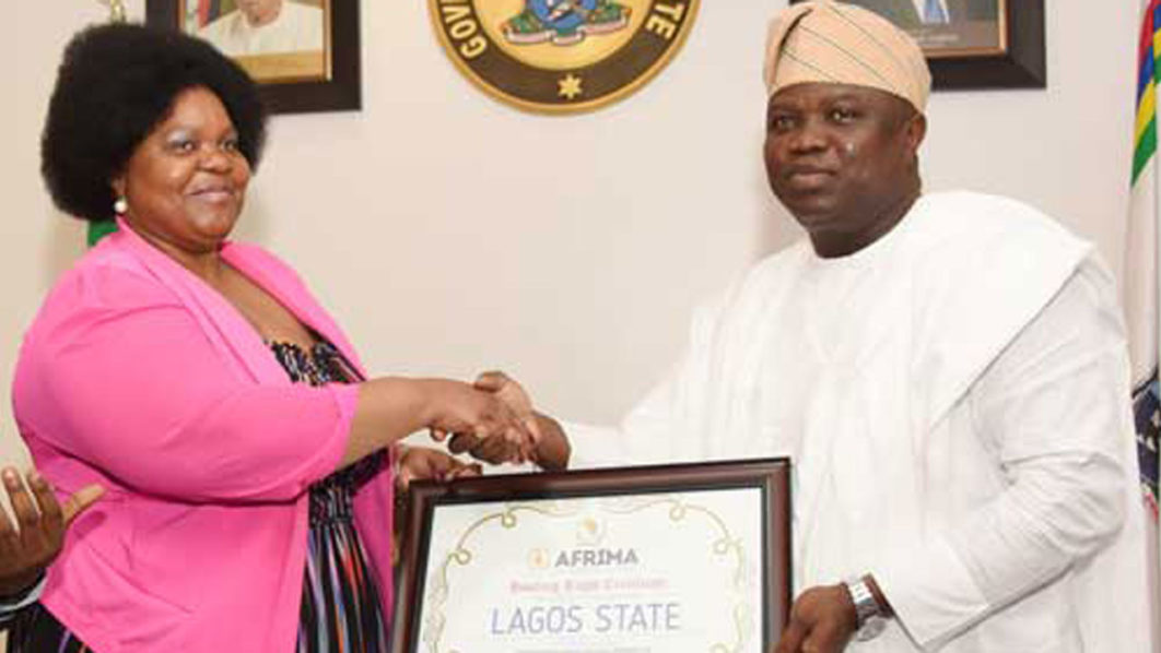 The-African-Union-Head-of-Culture-Ms-Angela-Martin-handling-the-AFRIMA-Host-City-Rights-to-the-Governor-of-Lagos-State-Governor-Akinwunmi-Ambodi