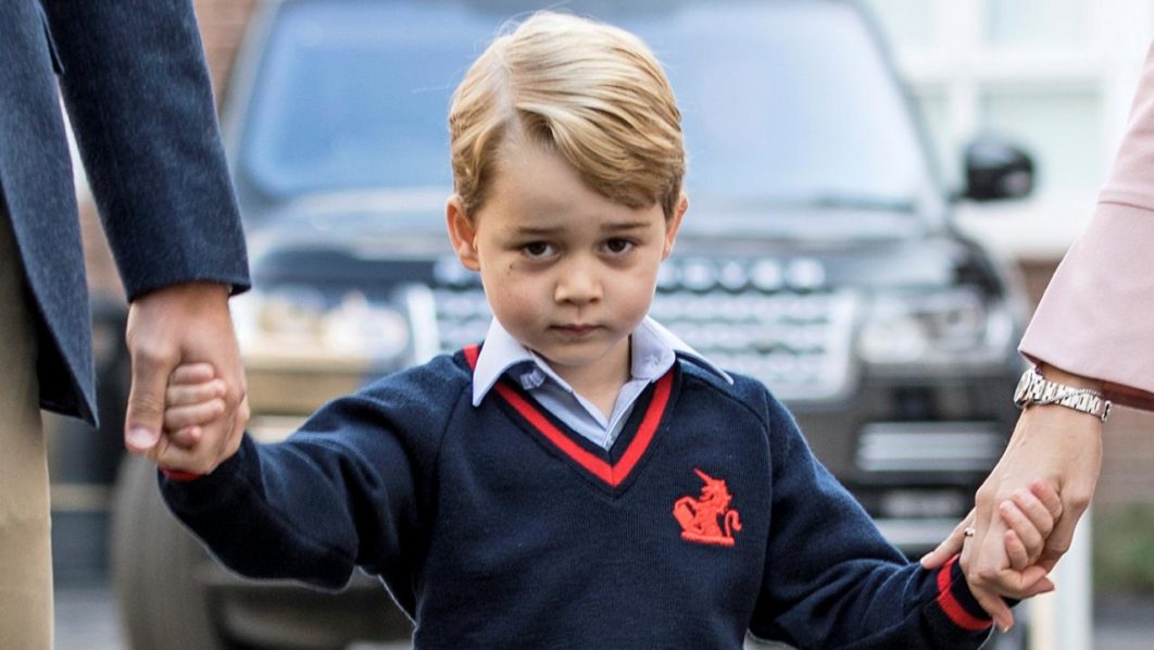 Prince George holds his father Britain’s Prince William’s hand as he arrives on his first day of school at Thomas’s school in Battersea, London