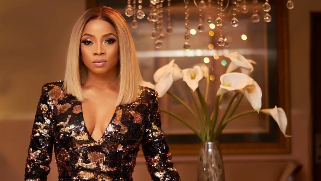 Toke Makinwa in a dress with shoulder pads. Photo_ MDN