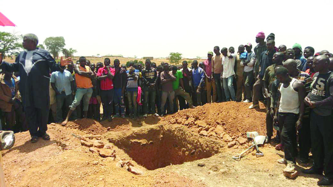 Digging the grave for mass burial in Plateau