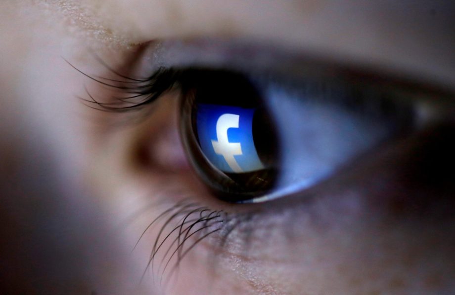 FILE PHOTO: A picture illustration shows a Facebook logo reflected in a person’s eye, in Zenica