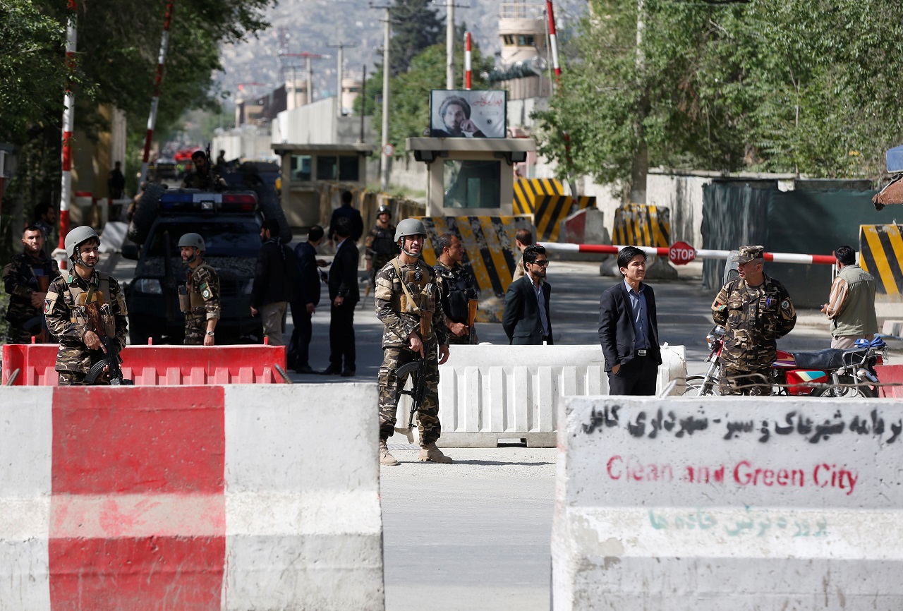 Afghan security forces stand guard near the site of a blast in Kabul, Afghanistan