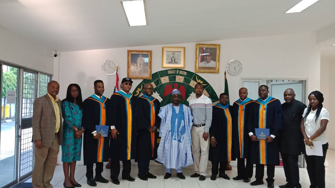 Nigerian Ambasador to Thailand with Nigerians who recently bagged their Masters Degree certificates