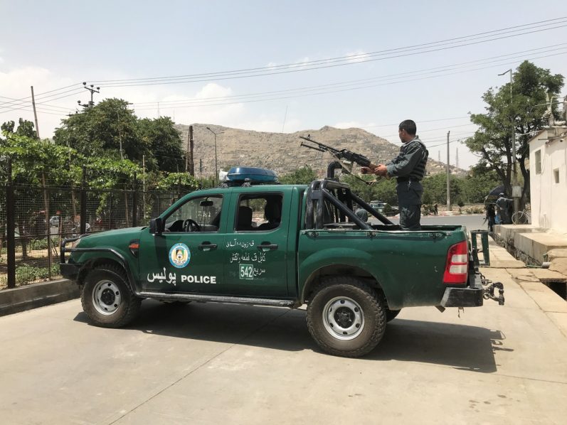 Afghan police officer keeps watch at the site of a blast in Kabul