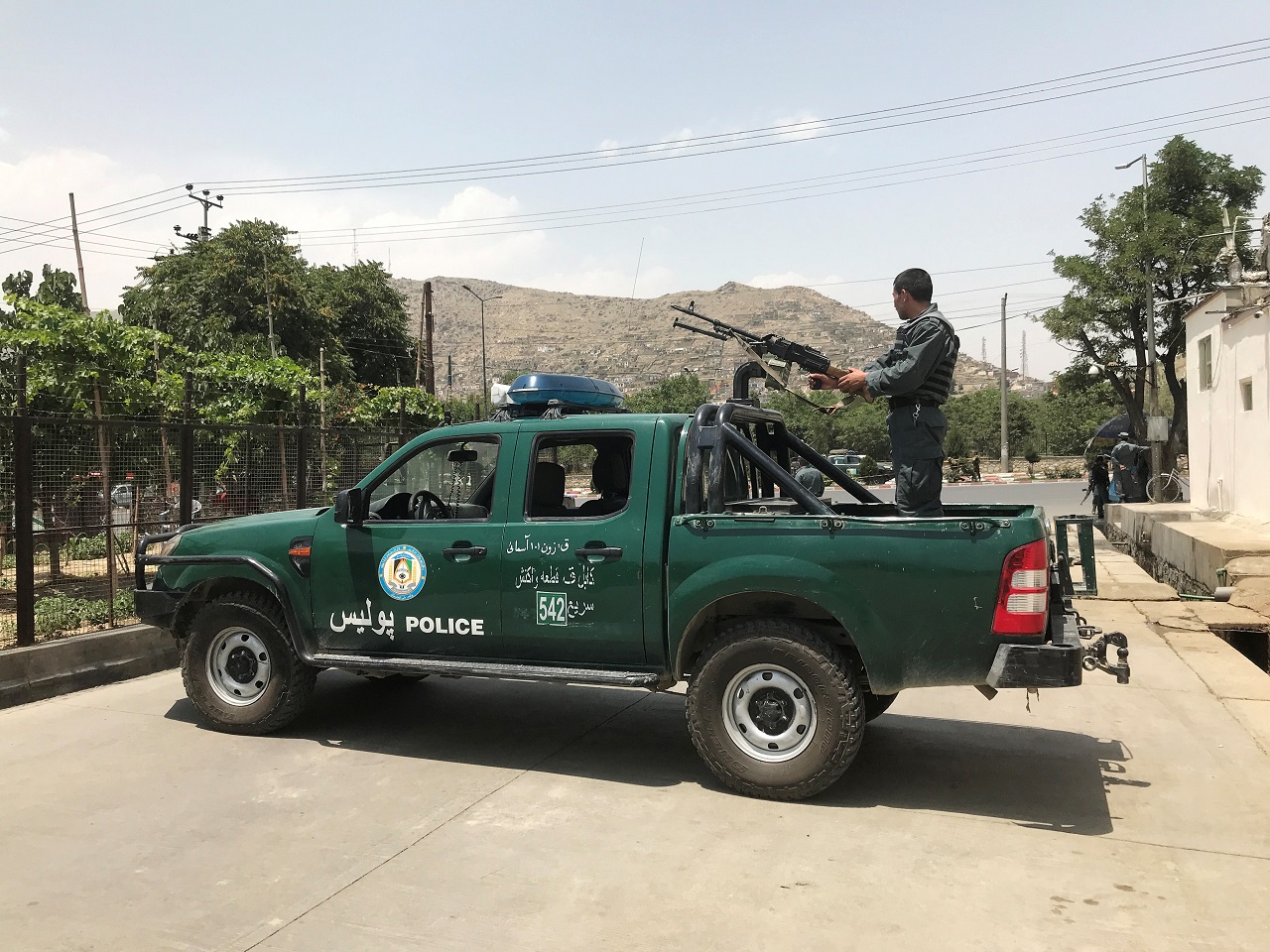 Afghan police officer keeps watch at the site of a blast in Kabul