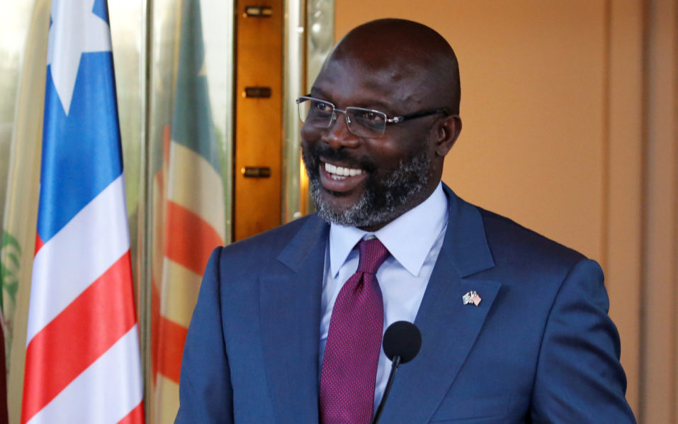 Liberia’s President George Weah laughs during a news conference at Presidential palace in Abidjan