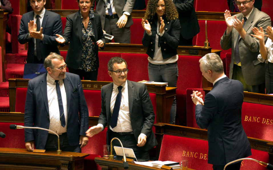 Members of parliament applaud French Finance Minister Bruno Le Maire and Minister for Public Action and Accounts Gerald Darmanin after the vote on part of the 2018 budget bill at the National Assembly in Paris