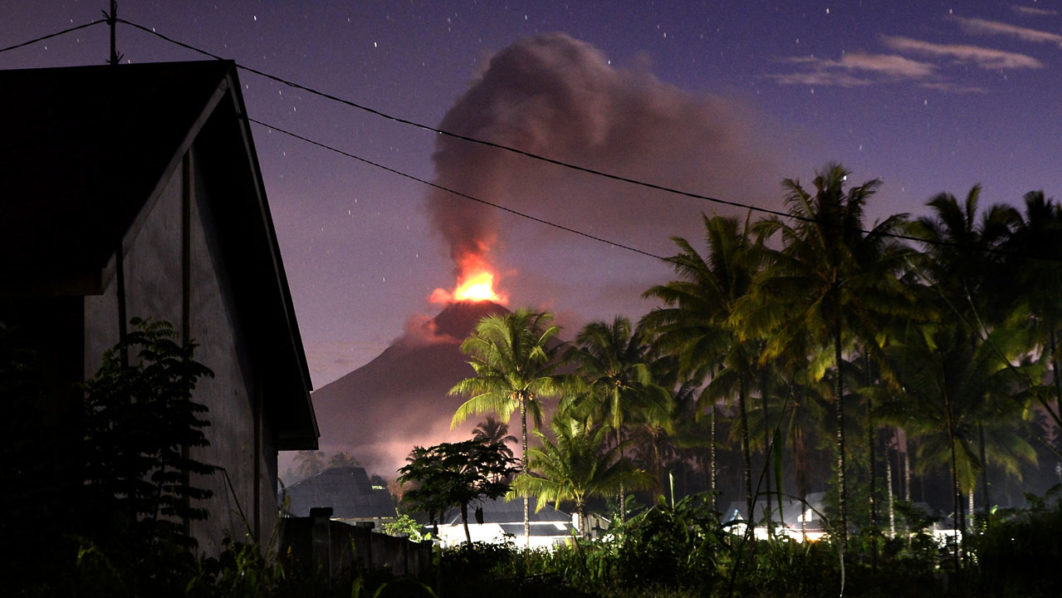 Indonesia’s Mount Soputan volcano spews lava and ash during an eruption as seen from Silian 3 village in Minahasa Tenggara