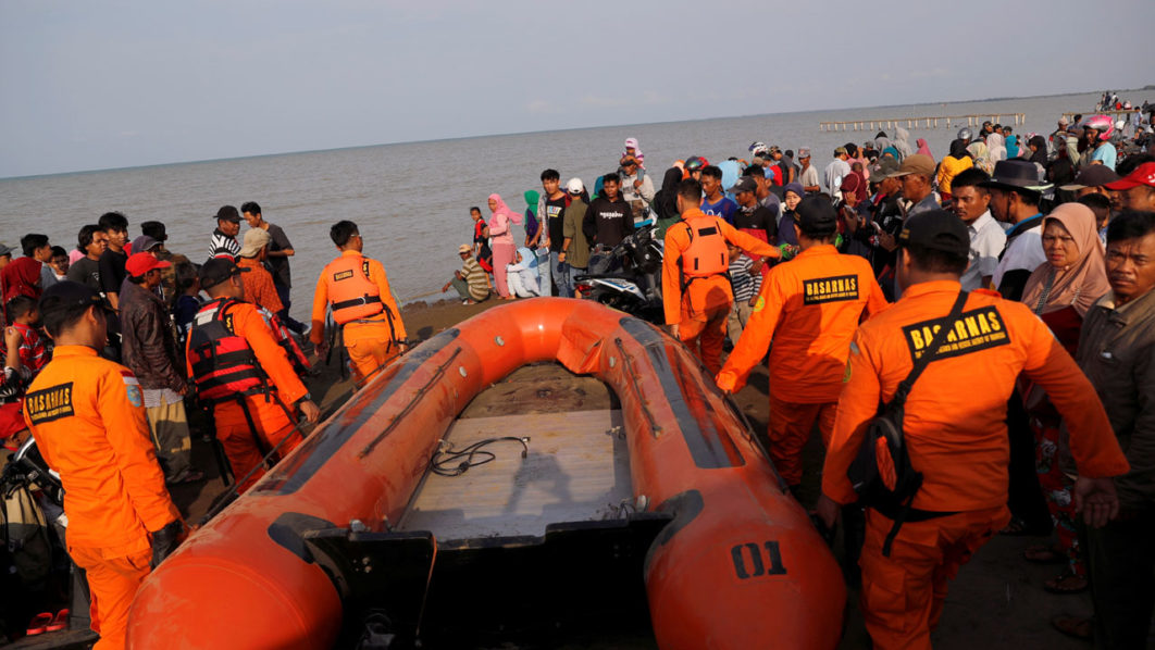 Rescue team members carry boat heading to the Lion Air, flight JT610, sea crash site off the coast of Karawang regency