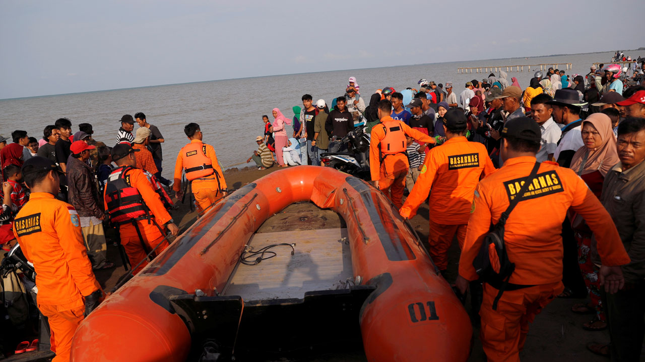 Rescue team members carry boat heading to the Lion Air, flight JT610, sea crash site off the coast of Karawang regency