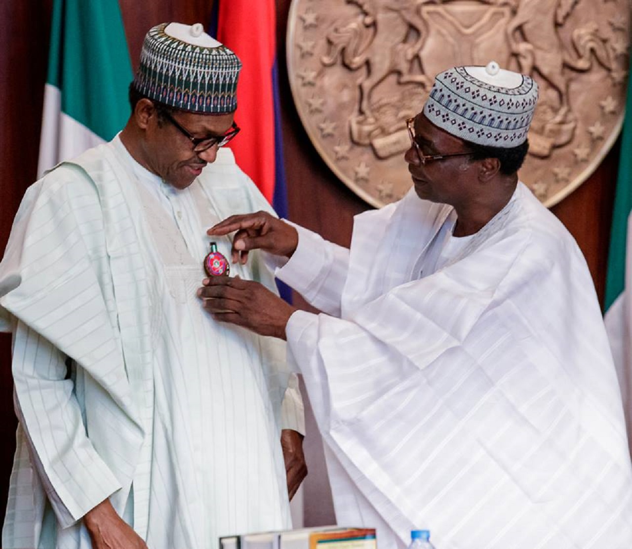 President Buhari being decorated by Chairman Nigerian Legion Brig. Gen. Adakole Akpa Rtd as he participates at the Emblem Appeal Launch for 2019 Armed Forces Remembrance Day celebration