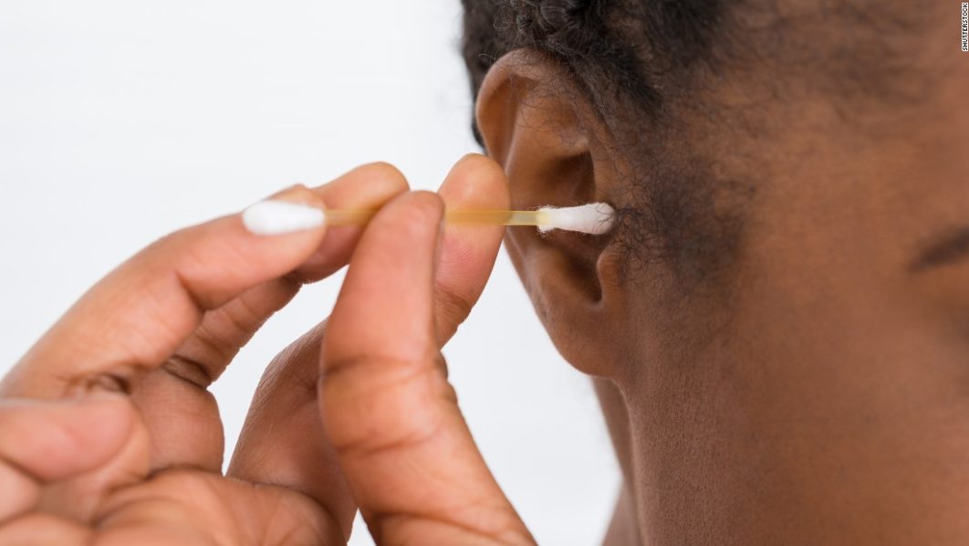 woman using cotton swab Source – CNN