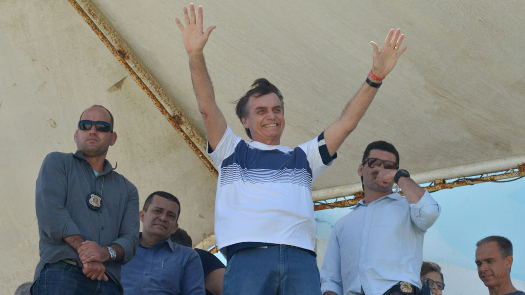 FILE PHOTO: Brazil’s new president-elect, Jair Bolsonaro, waves to supporters as he watches airplanes performing near his condominium at Barra da Tijuca neighbourhood in Rio de Janeiro