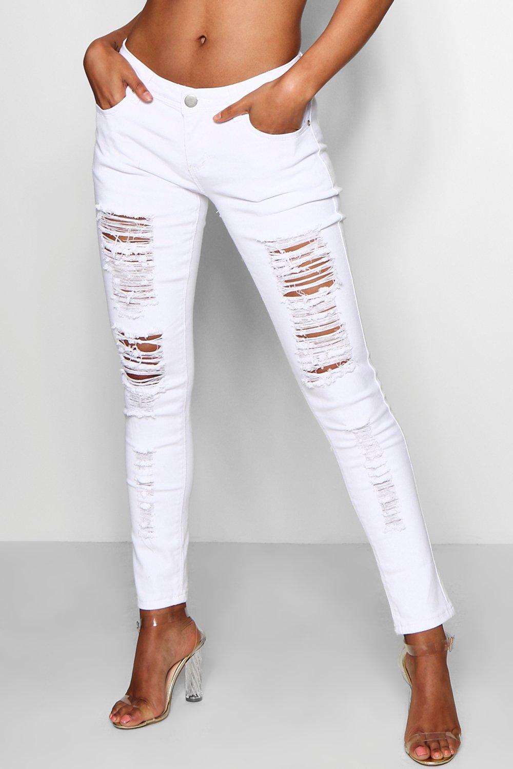 A lady wearing ripped white jeans 