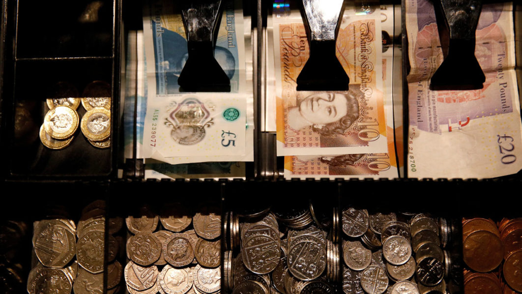 FILE PHOTO: Pound Sterling notes and change are seen inside a cash resgister in a coffee shop in Manchester