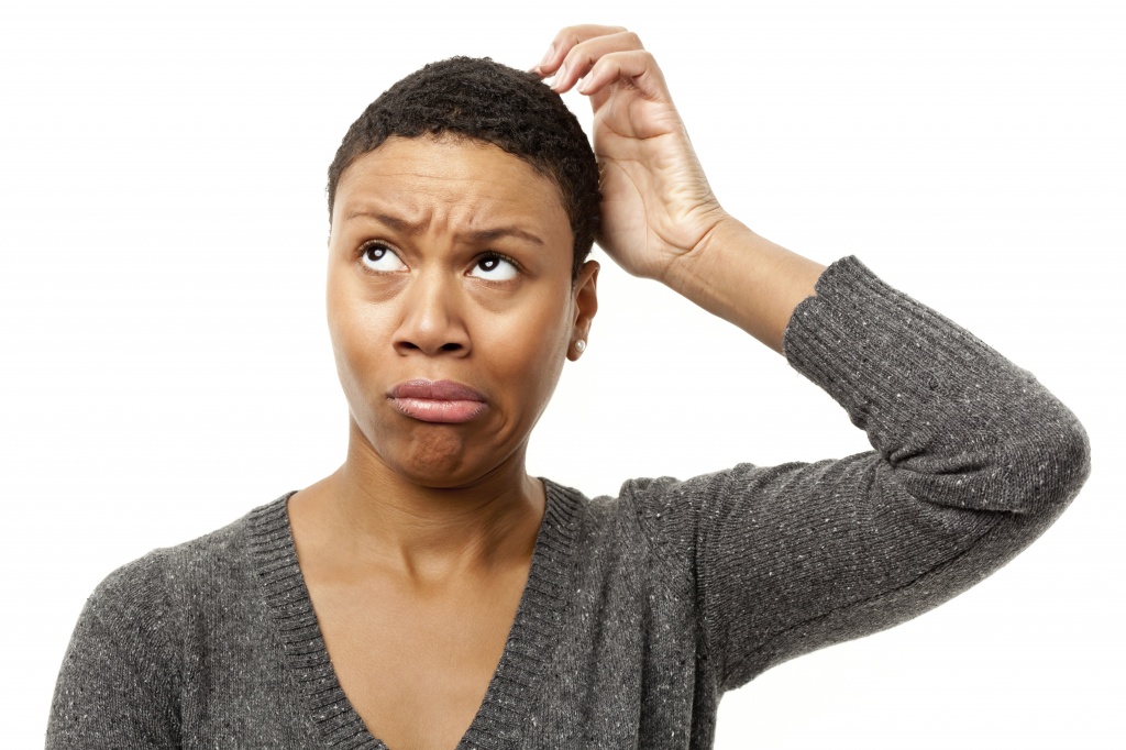 Confused Young Woman Scratching Head