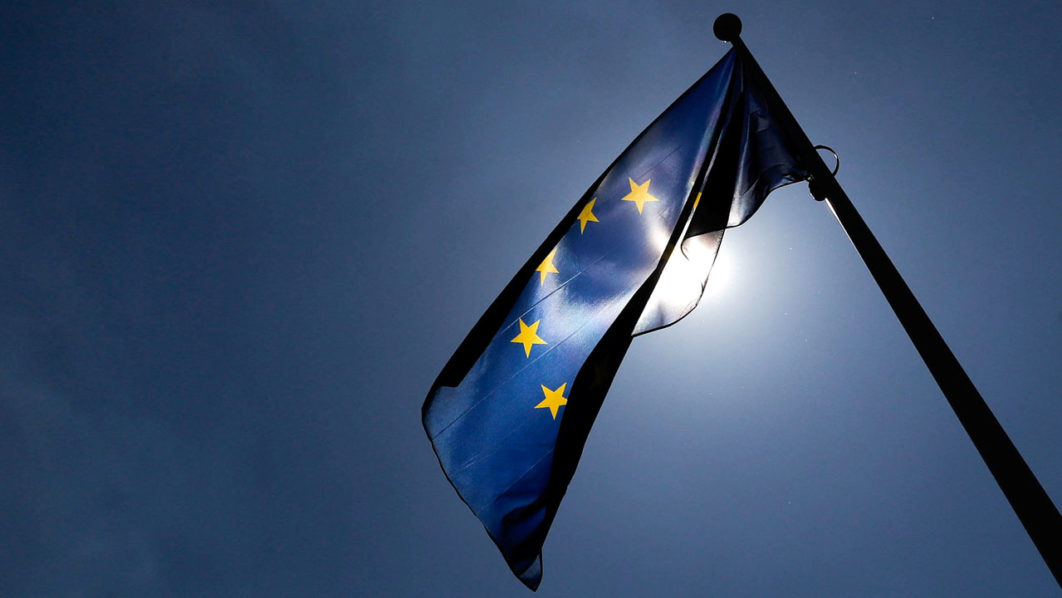 FILE PHOTO: A European Union flag flutters outside the EU Commission headquarters in Brussels