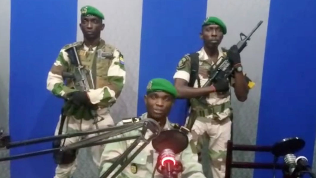 A still image taken from a video shows military officers giving a statement from a radio station in Libreville