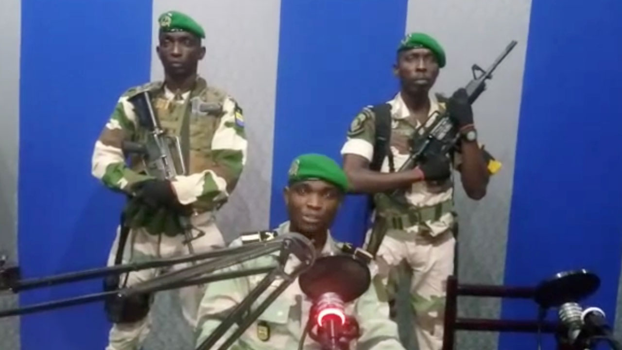 A still image taken from a video shows military officers giving a statement from a radio station in Libreville