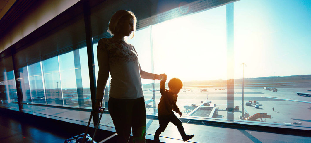 Mother and child at airport, Photo. Qatar Airways