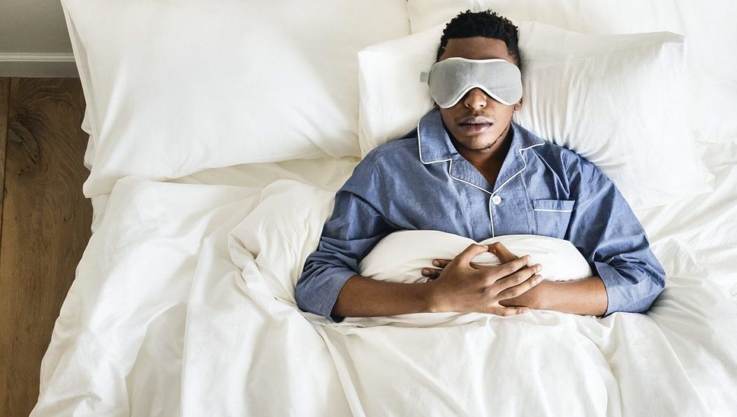 Man wearing sleeeping mask in bed, Photo. Pintrest