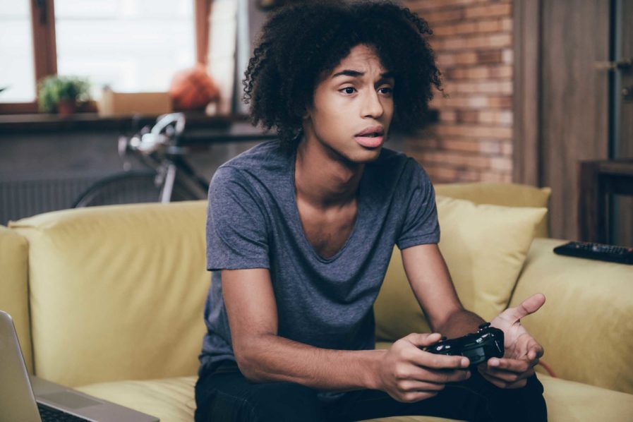 Boy playing video games, Photo. Reader’s Digest