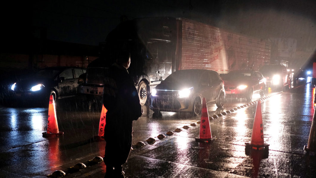 Policemen make traffic stop following an earthquake on a highway in San Salvador