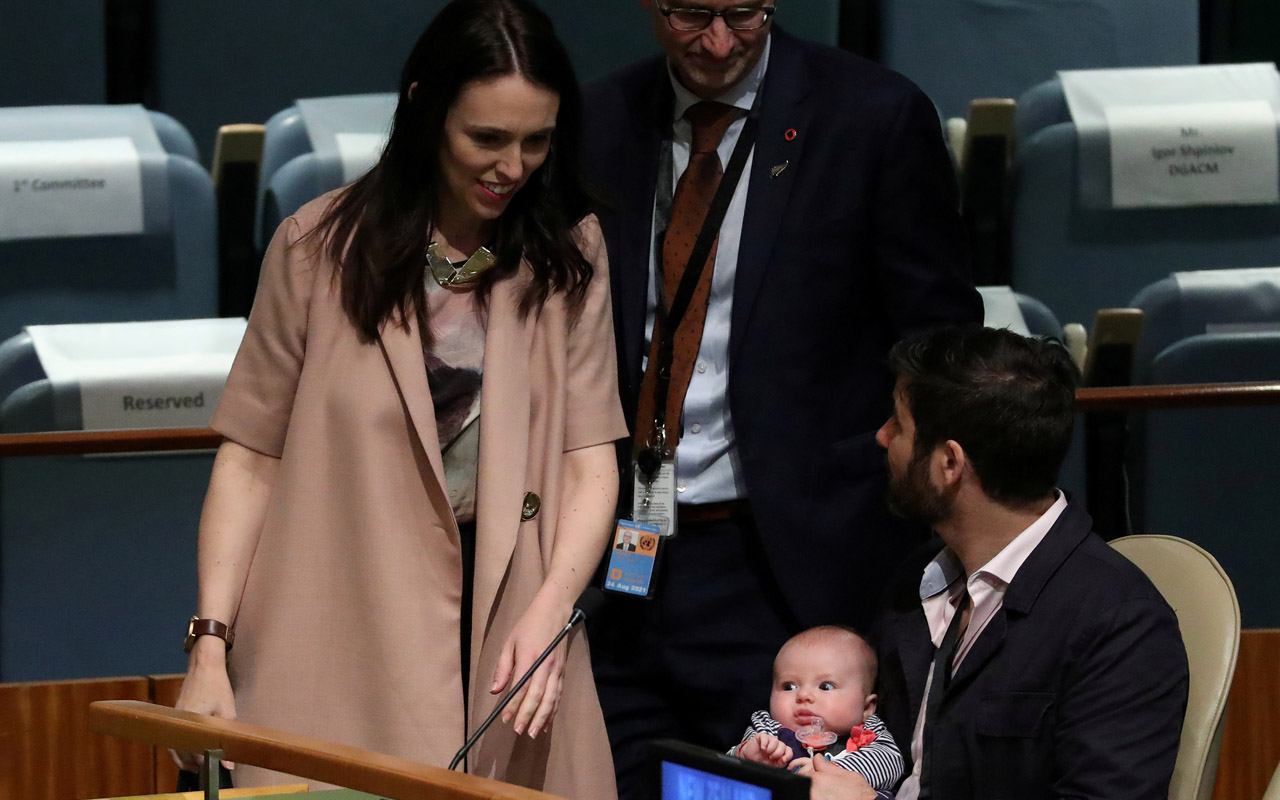 FILE PHOTO: New Zealand Prime Minister Jacinda Ardern walks back to her baby Neve and partner Clarke Gayford, after speaking at the Nelson Mandela Peace Summit during the 73rd United Nations General Assembly in New York City