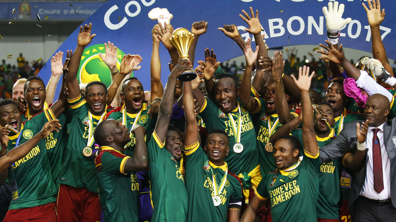 Cameroon’s Benjamin Moukandjo celebrates with the trophy and teammates after winning the African Cup of Nations