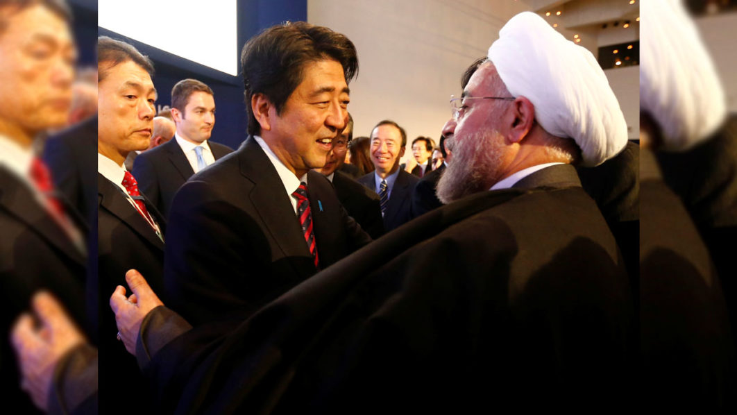FILE PHOTO: Japan’s Prime Minister Abe greets Iran’s President Rouhani  at World Economic Forum in Davos